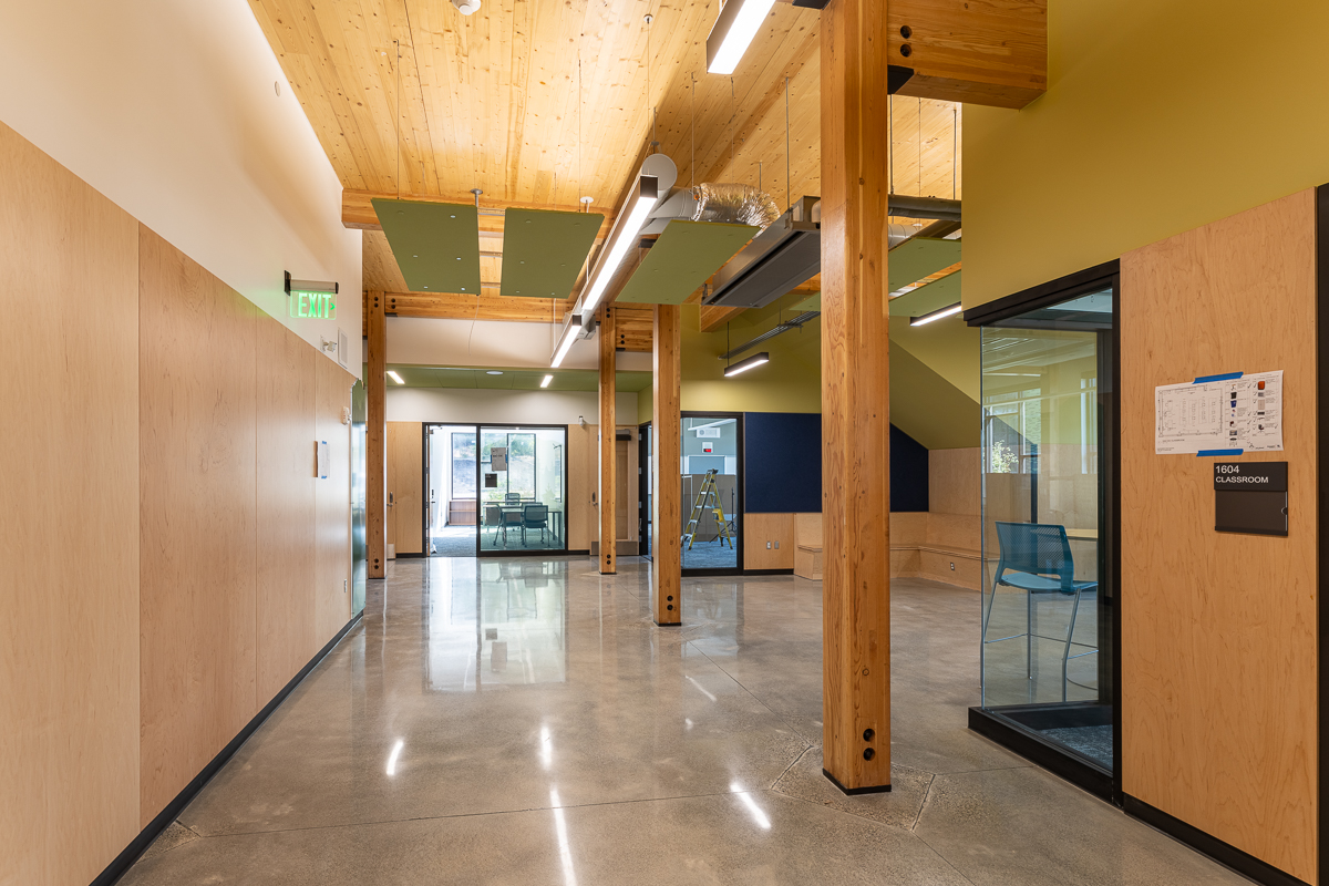 Corridor with exposed columns, beams, and CLT ceiling
