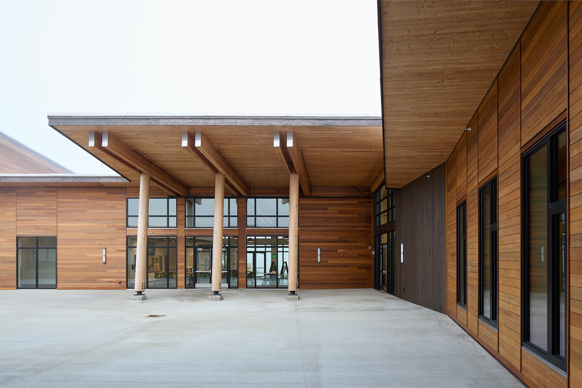 Central courtyard entrance with cedar siding and timber canopy
